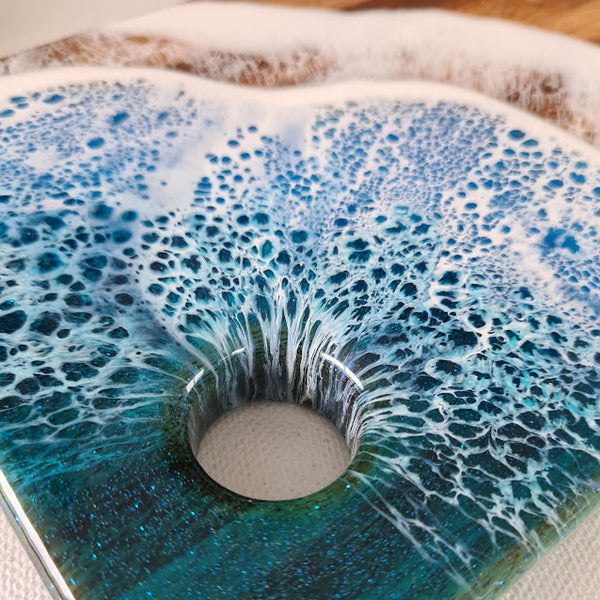 Close up of Ocean Blue Waves on grazer showing the resin lacing pouring through the hole