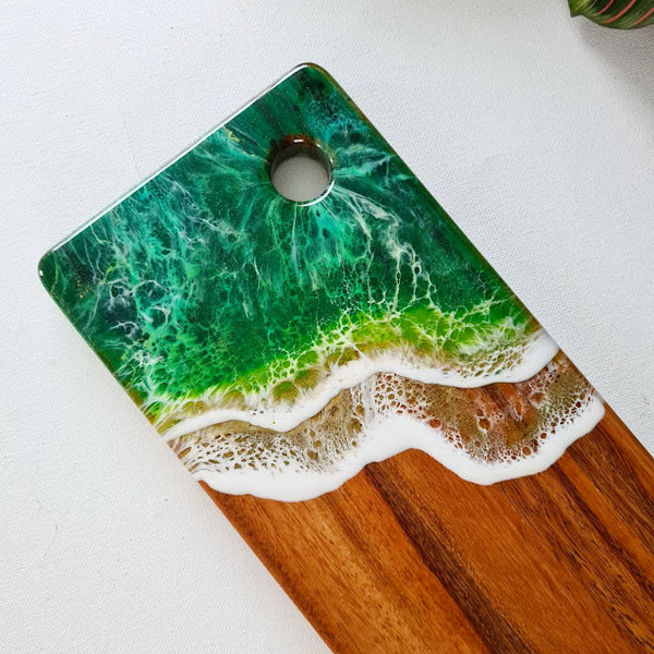 Close up of the Emerald Green Small rectangle Grazer showing the resin waves and the hole for hanging